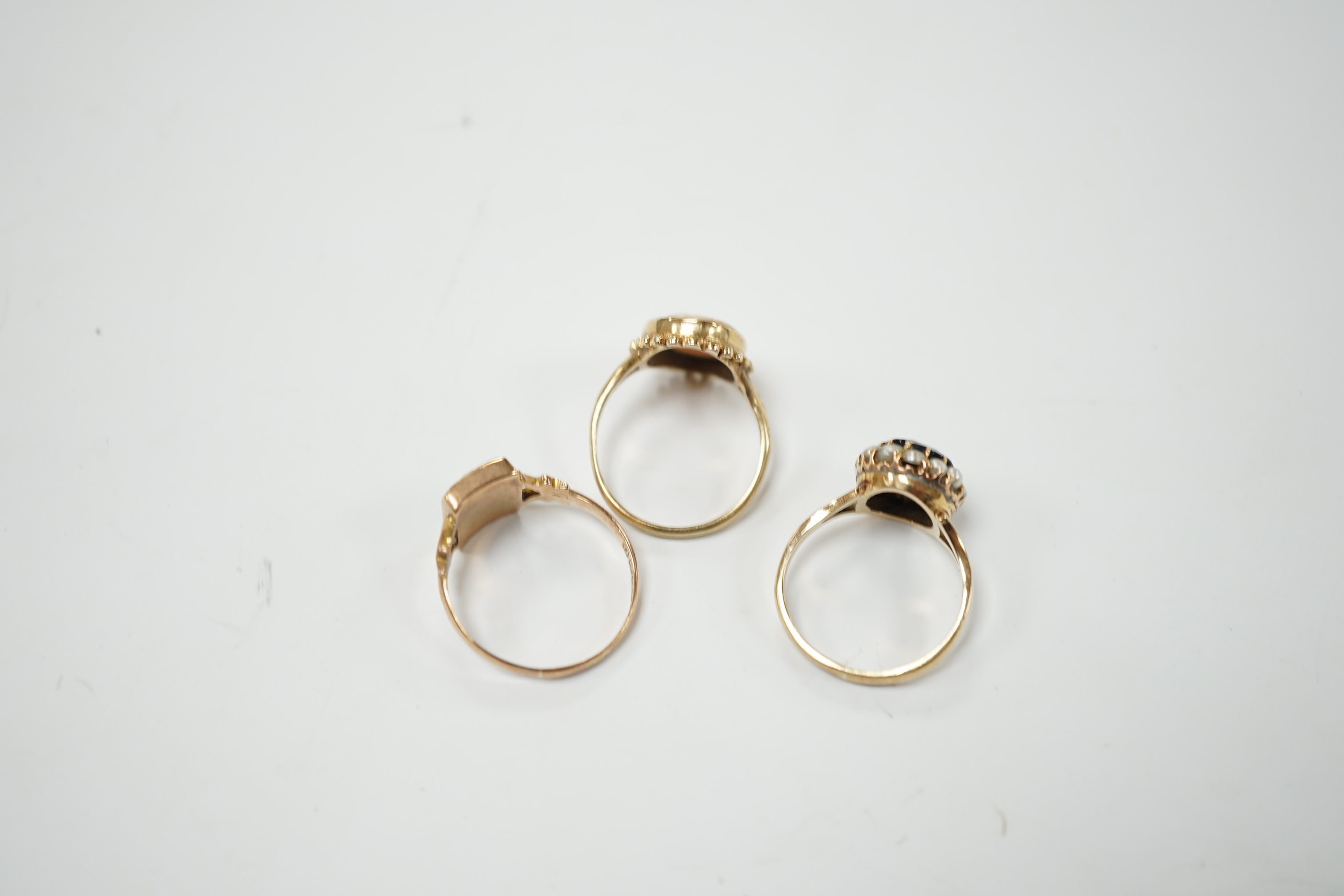 Two 9ct gold cameo rings, size N and Q, and a pearl and sapphire cluster ring, size N
